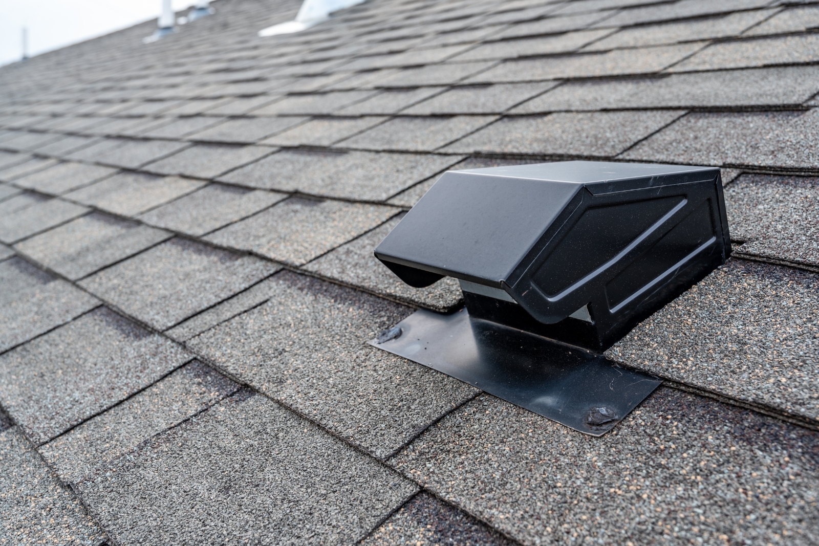 Static vent installed on a shingle roof for passive attic ventilation. attic insulation and roof ventilation