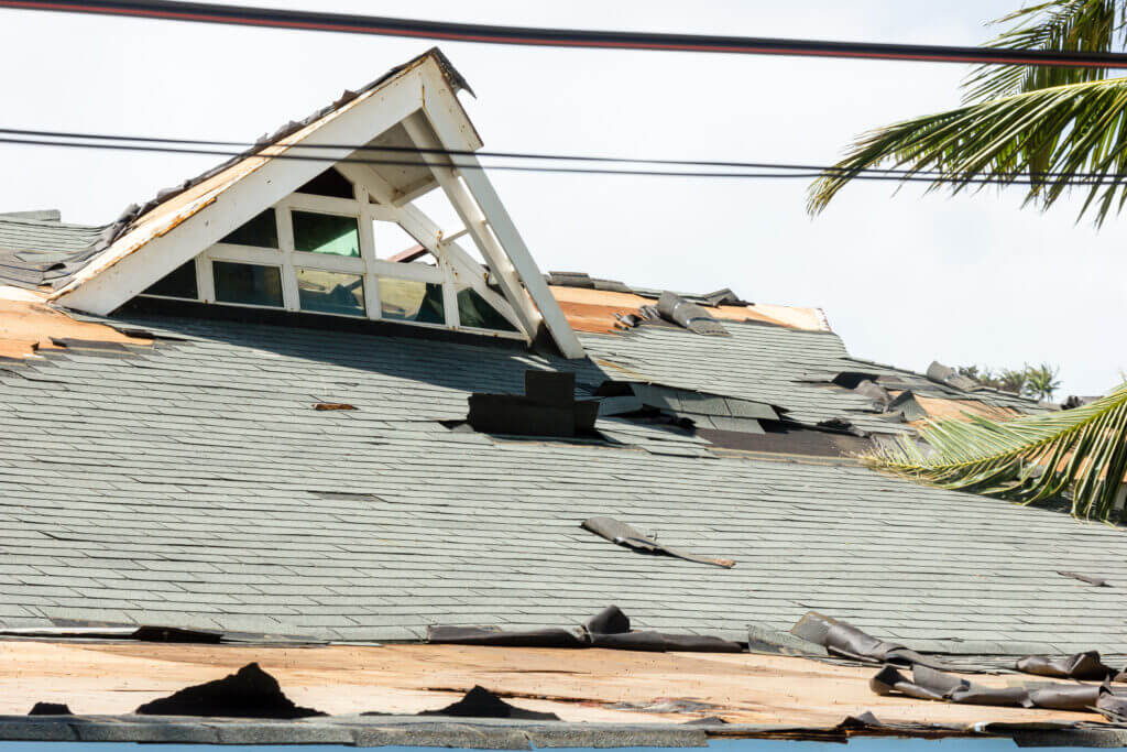 Close view of storm damage on shingles needing emergency roof repair in Decatur AL