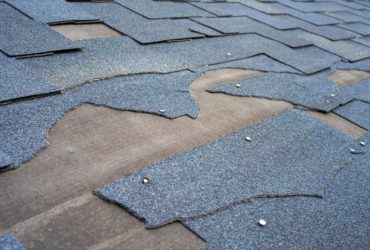 View of bitumen shingles roof damage that needs repair