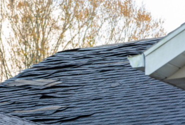 old asphalt roof shingles on house roof (1)