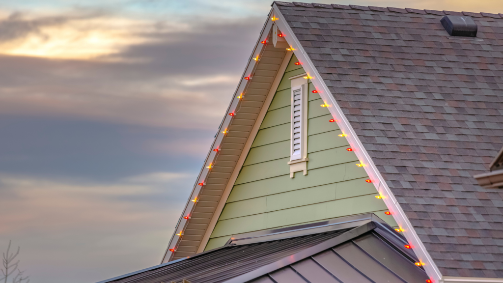 Roof with christmas lights against cloudy sky