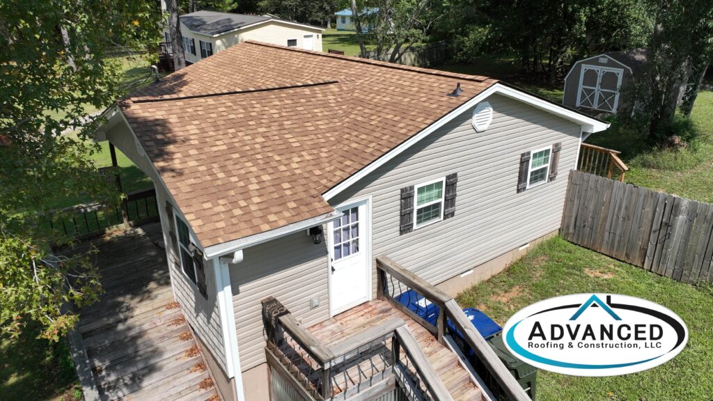 Freshly repaired shingles highlighting roof color energy efficiency Alabama on a suburban home