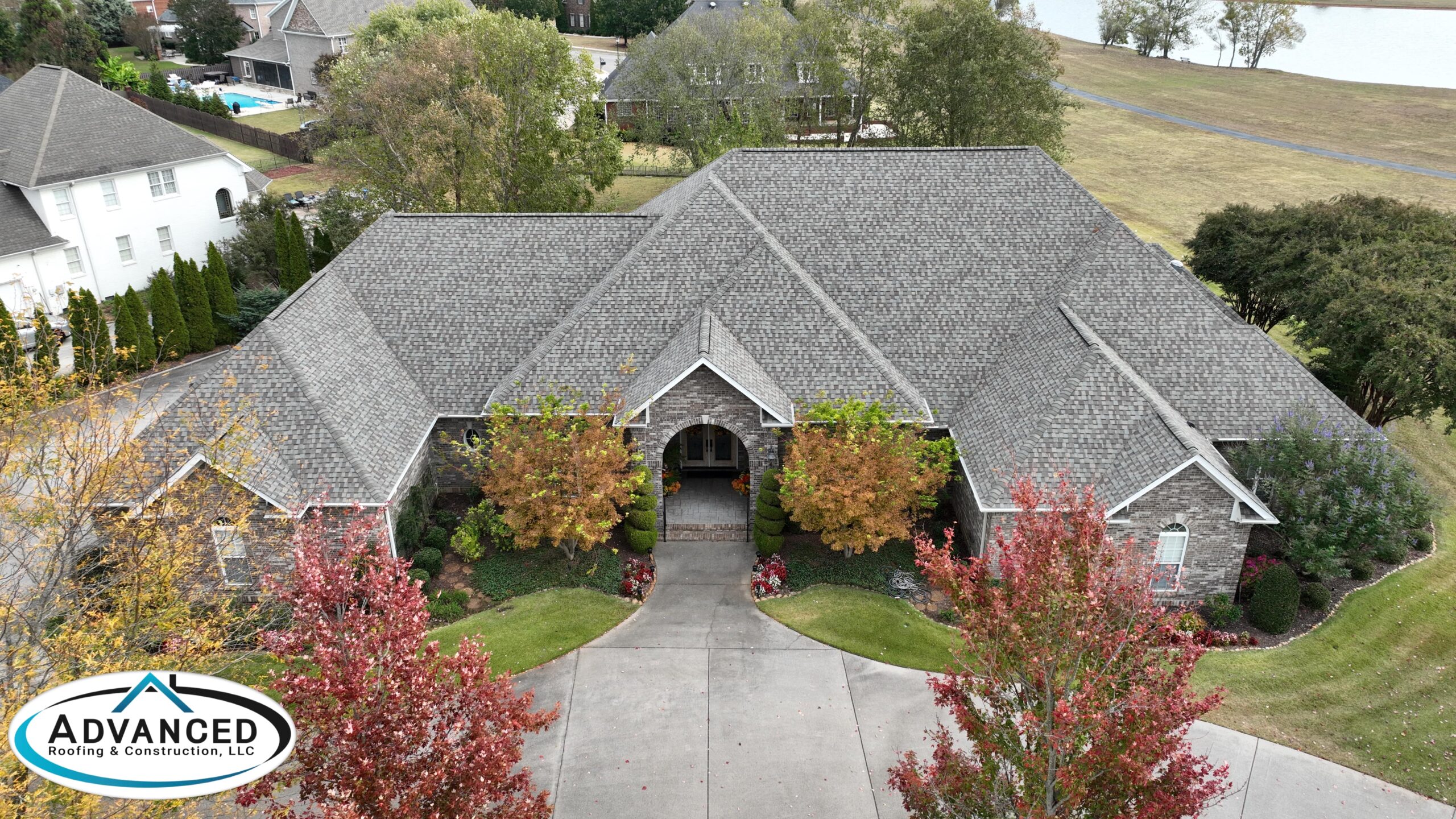 Roof replacement cost breakdown for a Huntsville AL residential home with new shingles being installed