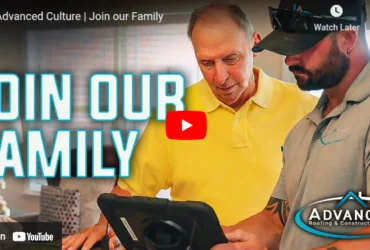 Roofing team members look at tablet with join our family text