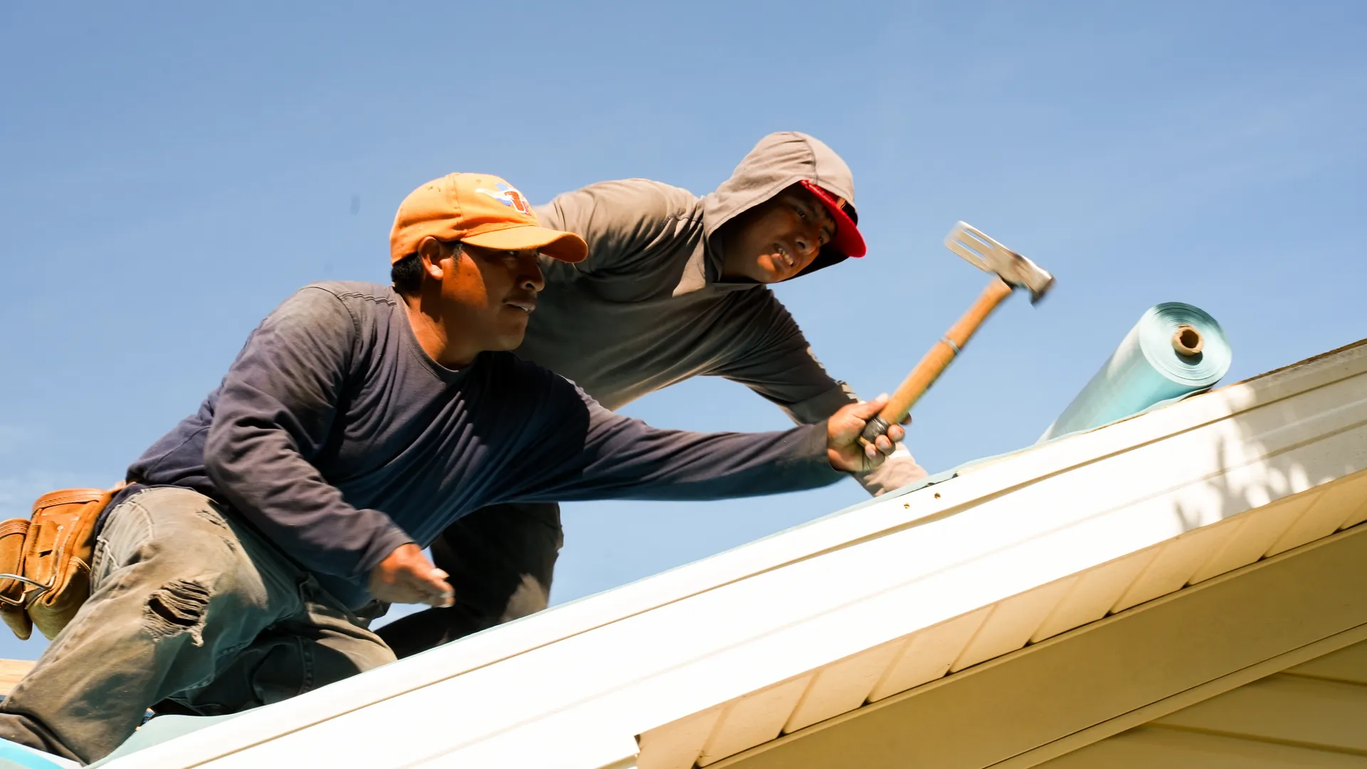 Advanced Roofing crew repairing a roof ridge in North Alabama